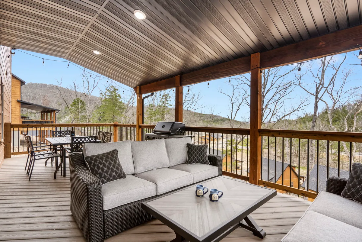 An elevated outdoor seating area featuring a dining table, grill, and panoramic mountain views. The setup encourages both casual relaxation and lively barbecues, echoing the blend of outdoor dining and natural splendor.